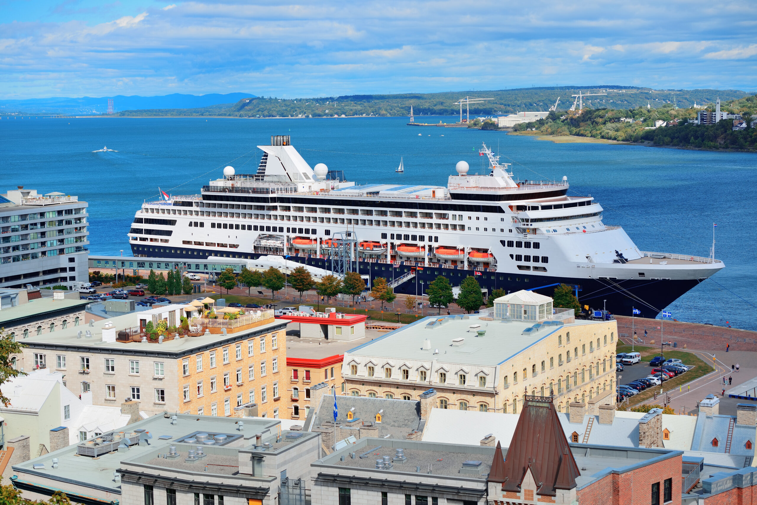 cruise ship river quebec city with blue sky historical buildings scaled